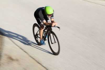 Man riding bicycle on road