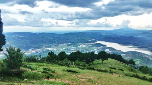 Scenic view of mountains against cloudy sky