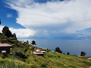 Scenic view of sea and buildings against sky