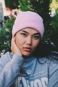 Close-up portrait of young woman wearing knit hat