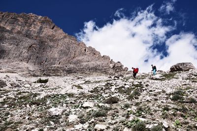 Low angle view of hikers hiking on mountain