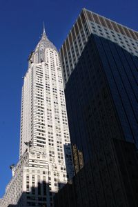 Low angle view of modern building against clear blue sky