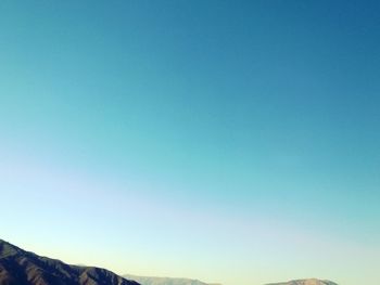 Scenic view of mountains against clear blue sky