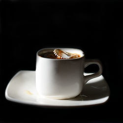 Close-up of coffee cup over black background