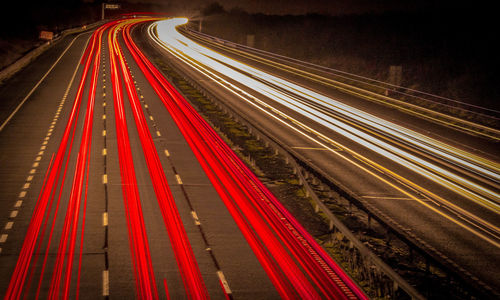 High angle view of light trails on road at night