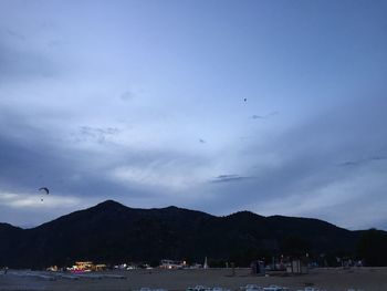 Scenic view of sea and mountains against sky