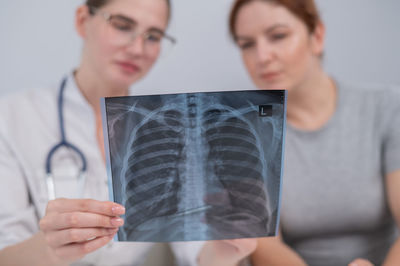 Midsection of man using mobile phone