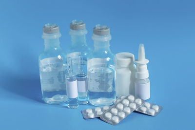 Close-up of bottles against blue background