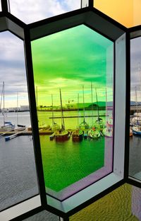 Scenic view of swimming pool against sky seen through window