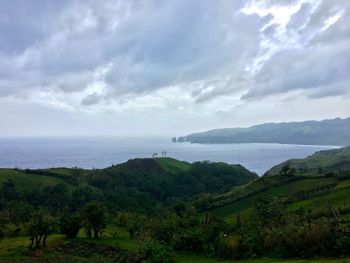 Scenic view of sea and mountains against sky