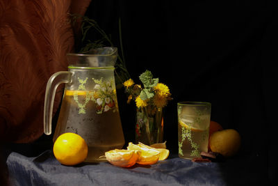 Fruits in glass jar on table