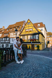 Woman on building against clear sky