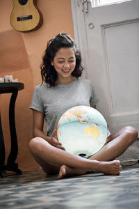 Our planet, our future. young woman with a world globe.  planning a great future.