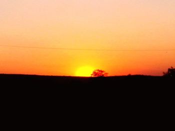 Silhouette landscape against clear sky during sunset