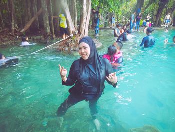 Full length portrait of woman enjoying in water