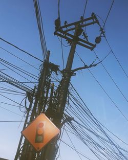 Low angle view of electricity pylon against sky