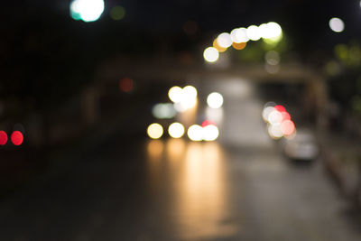 Defocused image of illuminated lights on street