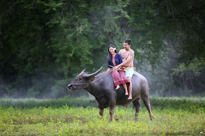 Man riding horse on field