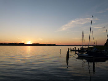 Boat in sea at sunset