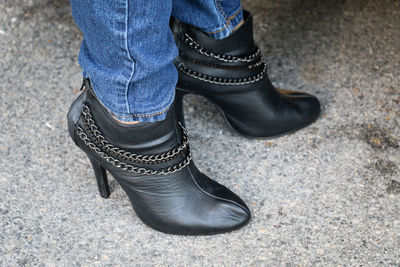 Low section of woman wearing shoes standing outdoors