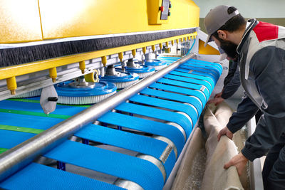 Side view of man working in factory