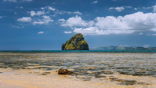 Surface level of rocks on beach against sky