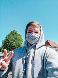 Portrait of young man against blue sky