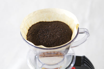 Close-up of coffee in glass filter on table