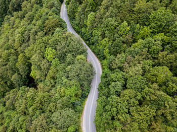 Winding road from high mountain pass, in summer time. aerial view by drone . romania