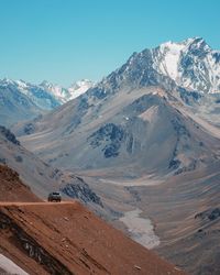 Scenic view of snowcapped mountains against clear blue sky