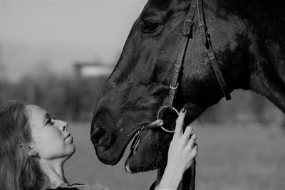 Side view of female rider with horse