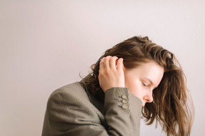 Portrait of a woman against white background