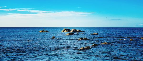 Scenic view of sea against blue sky