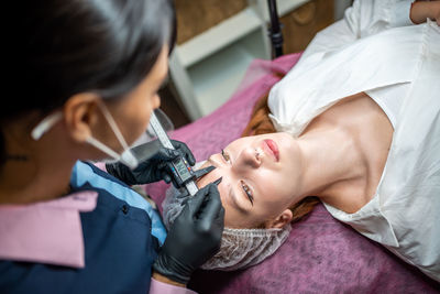 Midsection of doctor examining patient at clinic