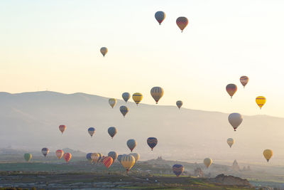 Low angle view of hot air balloons flying in sky