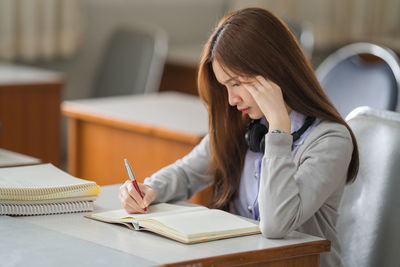 Young woman studying at classroom