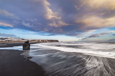 Scenic view of beach against sky during sunset