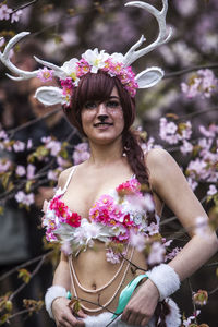 Close-up of woman holding pink flower