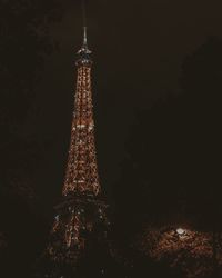 Low angle view of illuminated tower at night