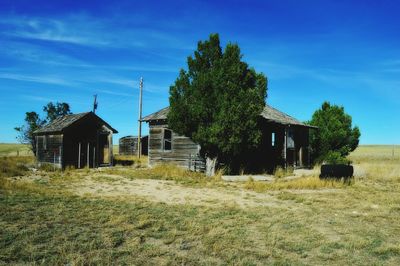 Abandoned house on field against sky