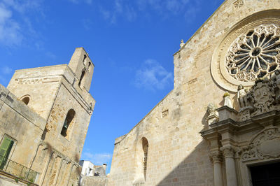 Low angle view of historical building against blue sky