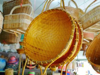 Low angle view of wicker container hanging in market stall