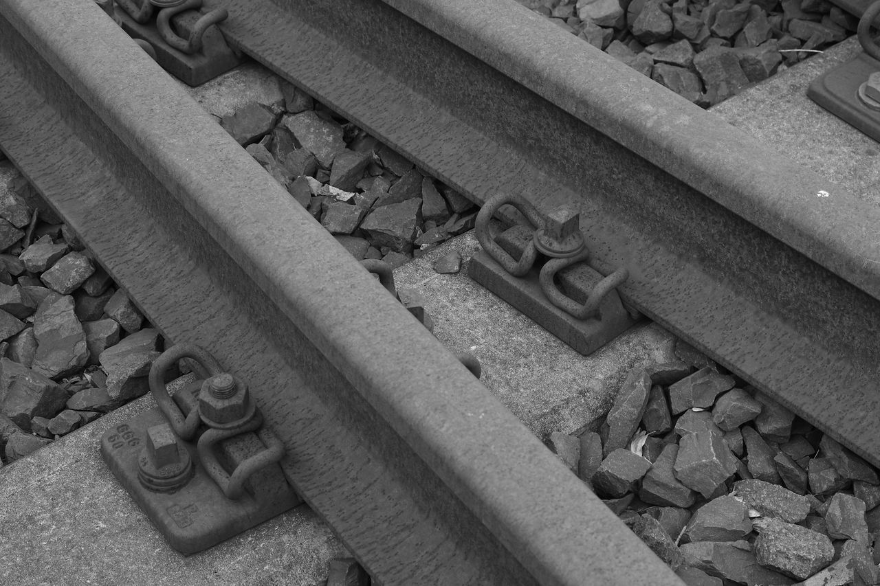 HIGH ANGLE VIEW OF STONES ON RAILROAD TRACK