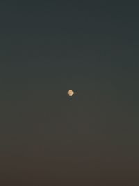 Low angle view of moon against sky at night