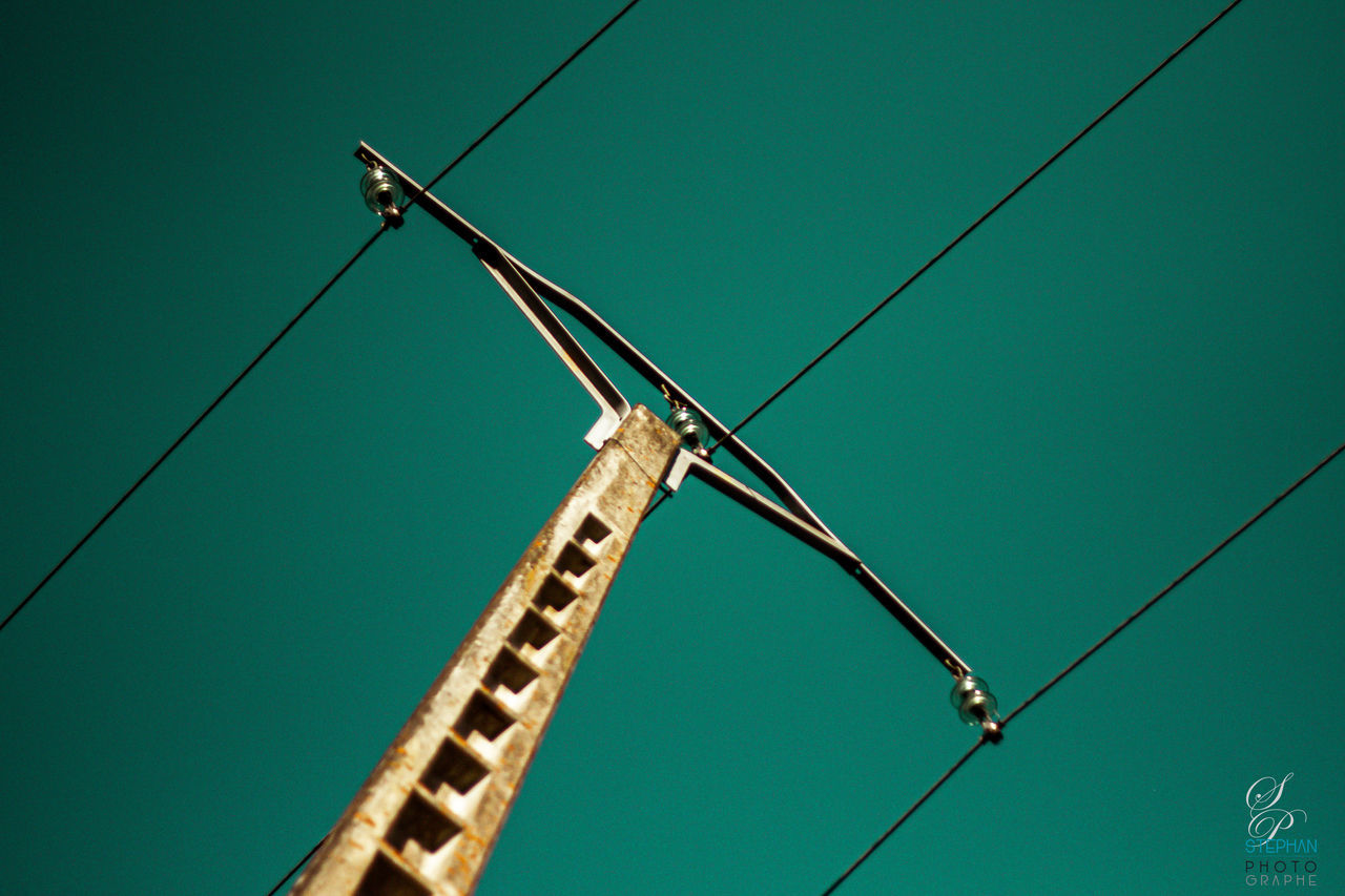 LOW ANGLE VIEW OF WIND TURBINES AGAINST CLEAR SKY