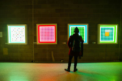 Full length of man standing in illuminated building