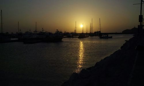 Boats moored at sunset