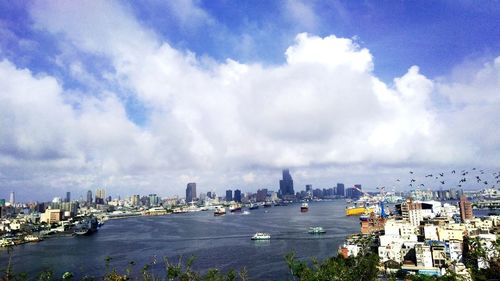 Panoramic view of sea and buildings against sky