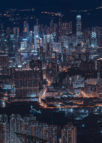 Digital composite image of illuminated cityscape against sky at night in kowloon peak