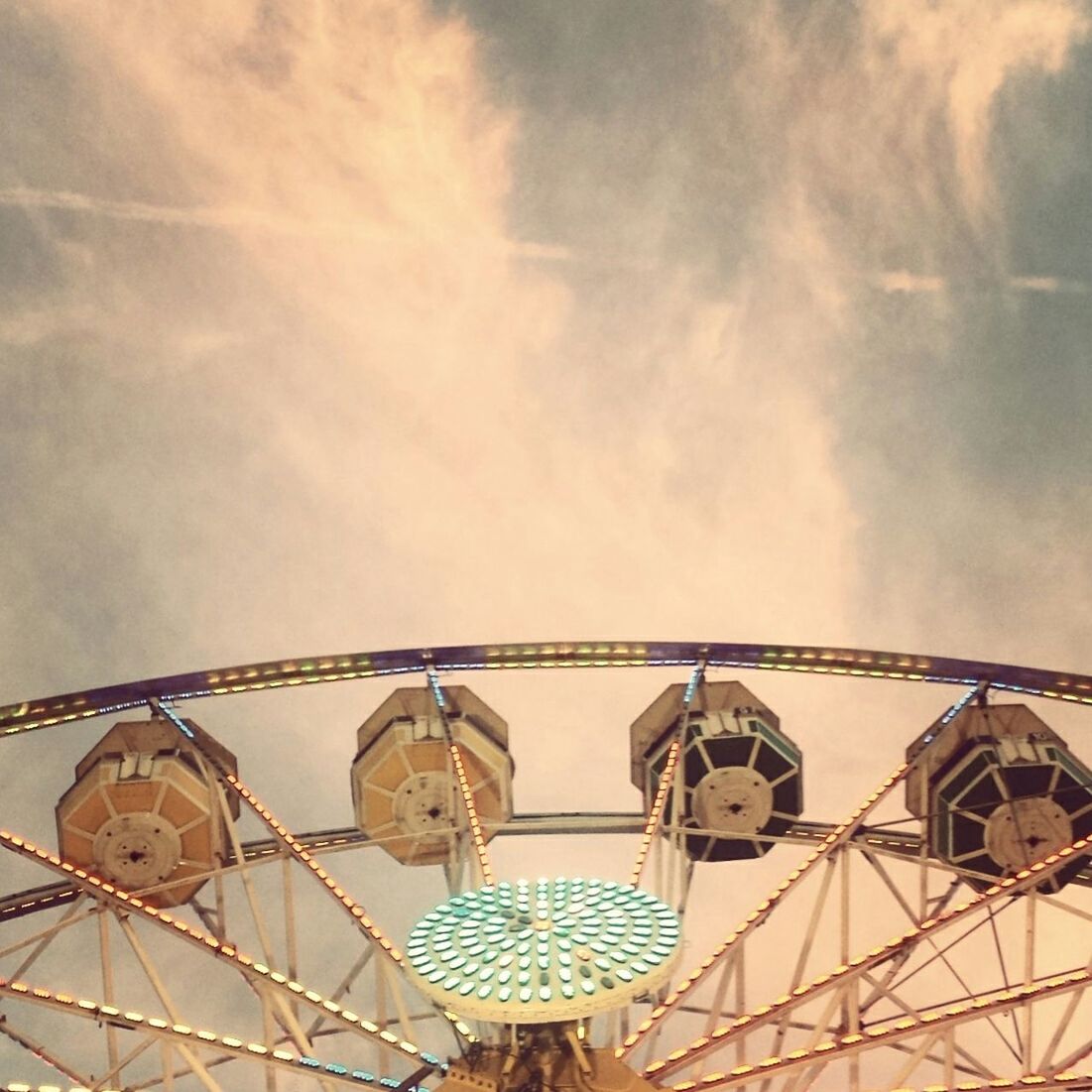 low angle view, sky, amusement park, architecture, built structure, amusement park ride, cloud - sky, arts culture and entertainment, ferris wheel, building exterior, cloudy, metal, dome, cloud, day, outdoors, no people, travel destinations, high section, metallic